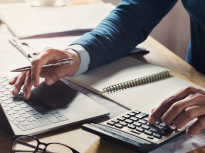 businessman workig and using calculator with laptop on desk businessman workig and using calculator with laptop on desk